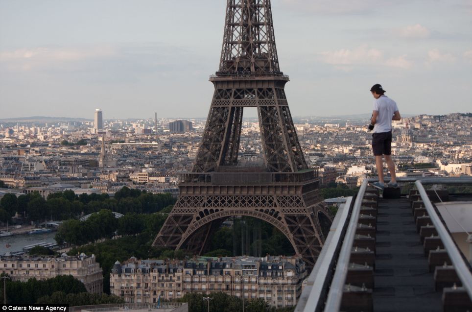 Mr Raskalov gets a view of the Eiffel Tower that few tourists in Paris get from a nearby rooftop. The pair capture every thrill-seeking moment on camera