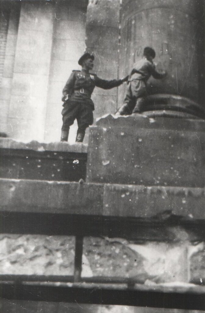Сын полка Володя Тарновский ставит автограф на колонне Рейхстага. Май 1945