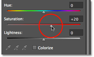 Dragging the Saturation slider in the Properties panel.