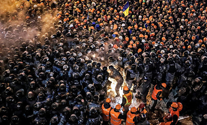Сотрудники спецподразделения милиции "Беркут" и коммунальных служб во время штурма лагеря сторонников евроинтеграции на площади Независимости в Киеве.