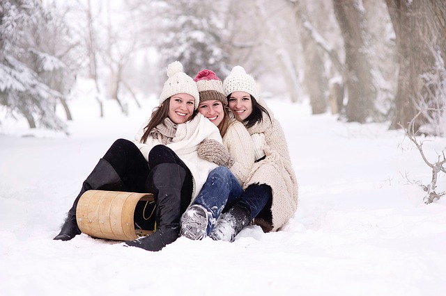 Three girls on a wooden sledge